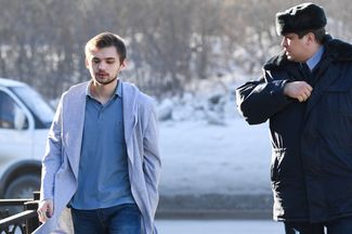 Blogger Ruslan Sokolovsky (left), charged with extremism and offending religious sentiment for playing Pokemon Go in a cathedral, arrives for a court hearing in Yekaterinburg on March 15, 2017.