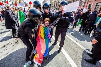 A woman is arrested at a protest rally against state-sponsored homophobia in Chechnya. St. Petersburg, May 1, 2017