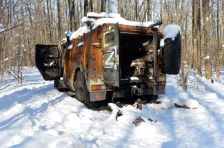 A Russian military vehicle, destroyed by the Ukrainian army, sits in the forest near Kharkiv. Nearby, a Russian soldier’s corpse is buried in snow. Kharkiv, like Kyiv, is currently still under Ukrainian control