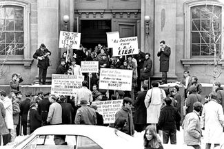 Война во Вьетнаме поляризовала американское общество. Сторонники войны зачастую были не менее активны, чем ее противники. На фото, сделанном 29 января 1968 года, сняты противники призыва и те, кто его поддерживал, возле унитарной церкви Арлингтона в Бостоне — там проводили консультации для американцев, пытавшихся избежать призыва