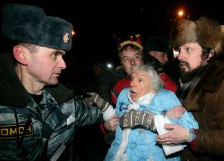 Police officers detain Lyudmila Alexeyeva during the Strategy 31 rally at Triumfalnaya Square on December 31, 2009