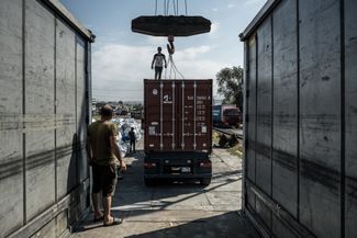 A container being loaded onto a truck at the Apaven freight terminal in Yerevan, Armenia. July 29, 2023.