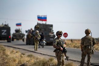 A Russian military convoy crosses an oil field in Syria's Al-Hasakah Governorate. 