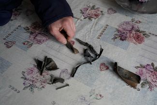 Vitaly, one of the residents from another part of the building, with fragments from the Kh-22 missile that hit the apartment block 