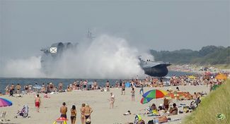 Отдыхающие на пляже наблюдают учебный маневр десантного корабля «Зубр». Калининградская область, 18 августа 2013 года