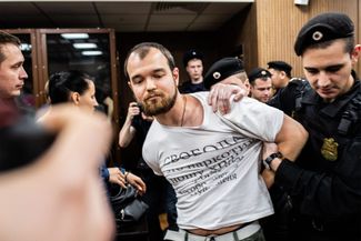 Alexey Minyailo, previously a suspect in the <a href="https://meduza.io/en/feature/2019/08/14/felonies-galore" target="_blank">felony allegations</a> against Moscow’s summer protesters, is arrested in court after throwing a rose at three other “Moscow case” suspects still on trial. December 6, 2019.