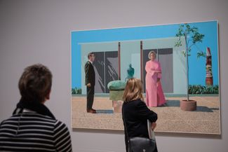 Visitors in front of the painting “American Collectors (Fred and Marsha Weisman)”