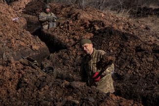 Украинские военные копают окоп.