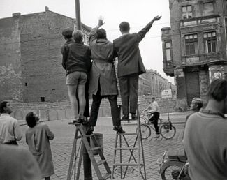 Residents of West Berlin waving to people on the other side of the border in August 1961 