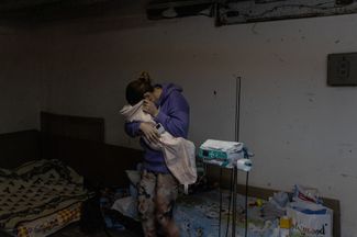 A mother and child in the basement of a Kyiv children’s hospital that serves as a bomb shelter