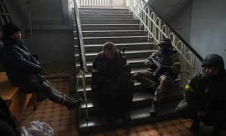 Members of the Ukrainian armed forces gather inside a school building in Debaltseve, January 30, 2015.