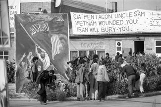 Иранские студенты, захватившие в заложники американских дипломатов во время Исламской революции. Надпись на транспаранте: «ЦРУ, Пентагон, Дядя Сэм! Вьетнам ранил вас. Иран вас похоронит». Тегеран, 22 декабря 1979 года 