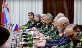 Oligarch Evgeny Prigozhin (second from the right, the only one in civilian clothing) during a meeting with Libyan rebel general Khalifa Haftar at the Russian Defense Ministry in November 2018. Russian Defense Minister Sergey Shoygu (fifth from the left) also attended the meeting.