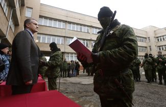 Новый глава правительства Крыма Сергей Аксенов принимает присягу у участника отряда самообороны в Симферополе, 10 марта 2014 года