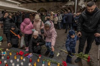 Люди возлагали цветы и зажигали свечи в память о погибших в войне