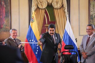 Николас Мадуро показывает Игорю Сечину копию сабли национального героя Венесуэлы Симона Боливара — во время подписания договора между «Роснефтью» и венесуэльской госкорпорацией PDVSA. Справа — гендиректор PDVSA Эулохио дель Пино. Каракас, 28 июля 2016 года