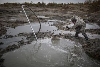 Black diggers look for amber near the village of Khabarovo, Kaliningrad region