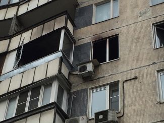 The window of the Meshcheryakovs' burned-out apartment in Moscow, where Bobokulova murdered the family's four-year-old daughter.