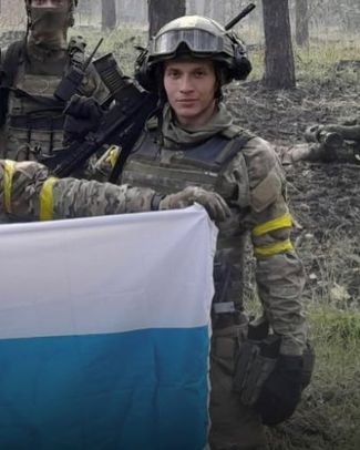 Дани Акель с бело-сине-белым флагом — неофициальным символом антивоенного движения в России