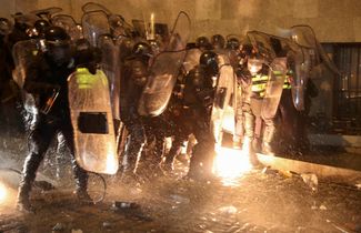 Protesters throw a Molotov cocktail at police