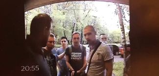 Police officers and witnesses go with Golunov to his home on June 6, 2019 to conduct a search