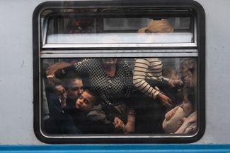 A woman and her children leaving Lviv. This shot was taken from a train going the opposite direction — to Lviv from the Polish city of Przemyśl. Many Ukrainians have decided to return to their country to protect their loved ones during the war. Poland, March 4, 2022