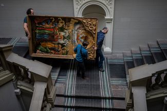 Museum workers move a painting in Lviv’s Andrey Sheptytsky National Museum to protect it from potential violence. March 4, 2022