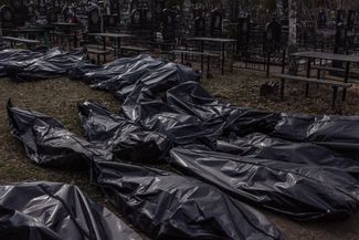Exhumed bodies at a cemetery. Bucha, Kyiv region, Ukraine. April 7, 2022.