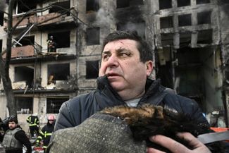 A man holds his cat killed by shelling in Kyiv.