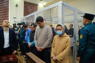 Uzbek protesters, including Lolagul Kallykhanova (front), who were charged for taking part in demonstrations in Nukus, Karakalpakstan, listen to the verdict in their trial in Bukhara. January 31, 2023.