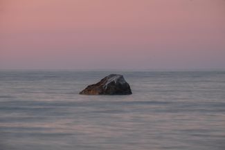 A rock in Pāvilosta that served as a boundary marker during the Soviet occupation — going any further along the coast was prohibited. July 2024.