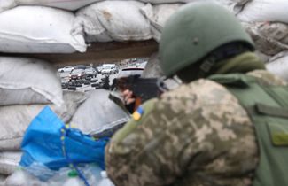 A member of the Ukrainian Territorial Defense Forces at a checkpoint in Kyiv