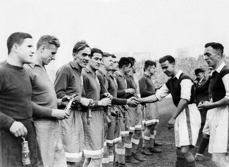 Dynamo and Cardiff City players shake hands before a match. Dynamo won 10 – 1. November 17, 1945