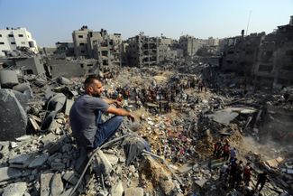 Мужчина на руинах одного из зданий, разрушенных в результате авиационного удара ЦАХАЛ по лагерю беженцев Джабалия на севере сектора Газа, 1 ноября 2023 года. По утверждениям ХАМАС, во время израильских атак в Джабалии погибли сотни человек, CNN со ссылкой на главу Индонезийской больницы в Газе сообщало о 80 убитых