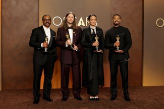 The Sinners cast, from left: director Ryan Coogler (Academy Award for Best Screenplay), composer Ludwig Göransson (Best Score), cinematographer Autumn Dorald Arkapaw (Best Cinematography), actor Michael B. Jordan (Best Actor).