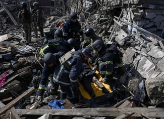 Rescuers retrieve the body of a person killed in a Russian air strike from under the rubble. March 16, 2026
