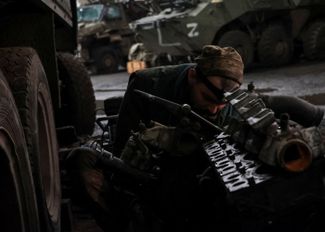 Украинский механик ремонтирует двигатель БТР