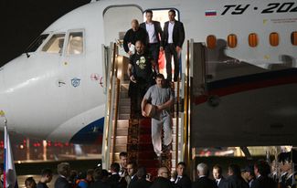 Pavel Rubtsov and other Russian citizens disembark from a plane at Moscow’s Vnukovo Airport following the prison swap. August 1, 2024. 