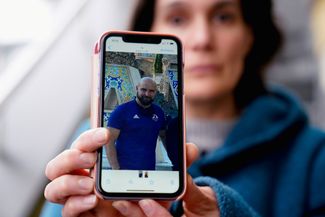 Pablo González wife Oihana Goiriena shows a photo of her husband after his arrest in Poland. March 5, 2022.