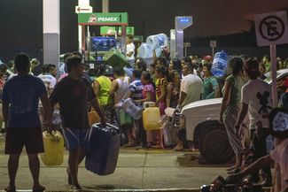 Люди воруют топливо на бензозаправке в городе Сан-Мигель-де-Альенде, 3 января 2017 года