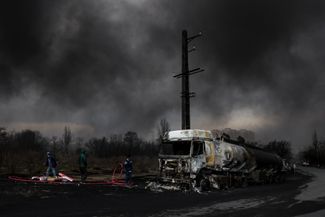 A burning fuel tanker on the side of the road in Tehran