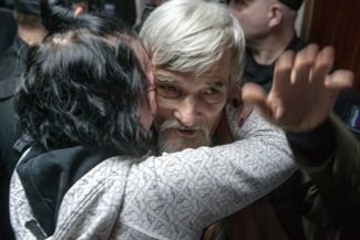 Yuri Dmitriev’s daughter, Katerina Klodt, hugs her father after his acquittal by the Petrozavodsk City Court, April 6, 2018