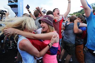Fans celebrate Russia’s victory at the fan zone in Moscow, July 1, 2018