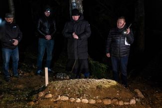 Imam Aleksander Bazarewicz (center) says a prayer during the funeral ceremony of a 19-year-old Syrian refugee who drowned in the border river trying to get to Poland. Bohoniki, November 15, 2021.