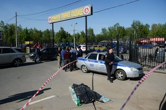 Police officer outside Moscow's Khovanskoye Cemetery, following a deadly shootout, May 14, 2016