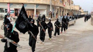 ISIS fighters march through Raqqa. January 14, 2014.