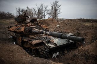 A Ukrainian tank disabled along the road into the village of Metalist, outside Luhansk. November 13, 2014.