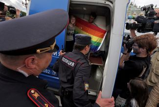 Supporters of the LGBTQ community are forced into a police vehicle in St. Petersburg's Palace Square. August 2, 2015