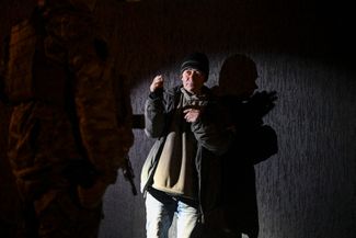 A resident of Lviv, who found himself on the street at night during the curfew.  Terrodefense fighters who notice violators, interrogate them and demand documents