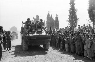 Residents of the Afghan regional capital Khost greet Soviet soldiers returning from an operation against the mujahideen. May 26, 1986